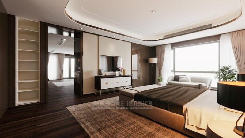 Phòng ngủ biệt thự được trang trí đẹp với những đồ vật như giường bọc vải, kệ trang trí, kệ decor, thảm trải sản, sàn gỗ....